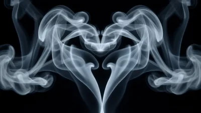 Symmetrical White Smoke Forming A Heart Shape