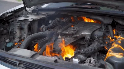 Car Engine Burning With Intense Flames Under Open Hood
