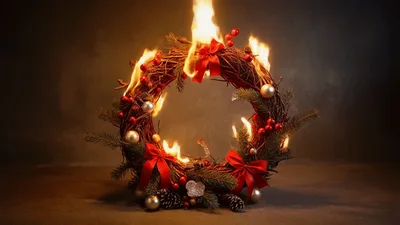 Burning Christmas Wreath With Red Bows And Ornaments