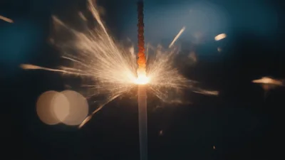 Burning Sparkler Emitting Bright Golden Sparks