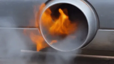 Car Exhaust Pipe Emitting Flames And Smoke