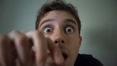 Young Man Staring Intently At Camera Lens