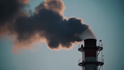 Industrial Chimney Emitting Thick Dark Smoke Into Sky