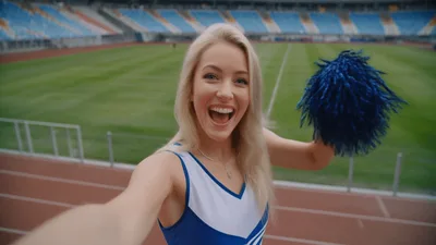Blonde Cheerleader Recording Selfie Video At Empty Stadium