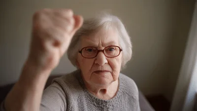 Elderly Woman Raising Her Fist In Protest