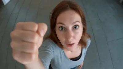 Woman Looking Up And Showing A Fist