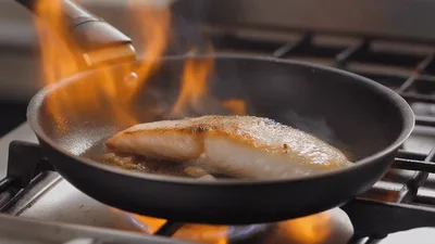 Fish Fillet Searing In A Flaming Frying Pan