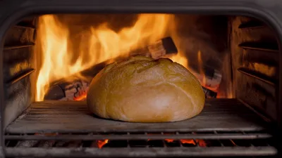 Round Loaf Of Bread Baking In Wood Fired Oven
