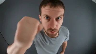 Man Punching Towards Camera In Aggressive Manner