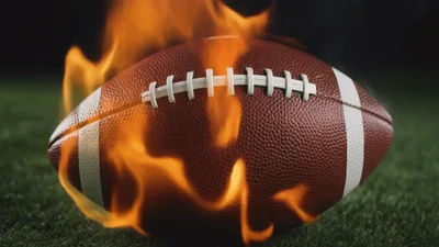 American Football Ball Burning On Grass Field