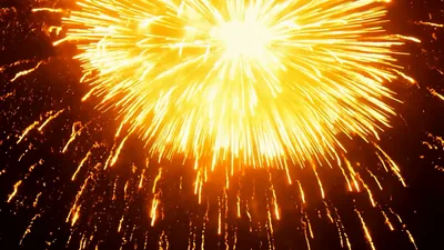 Golden Fireworks Exploding Against Dark Night Sky