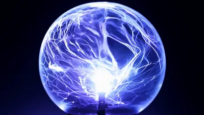 Plasma Ball Glowing With Electric Arcs In Dark Room