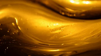 Golden Liquid Surface Rippling In Slow Motion