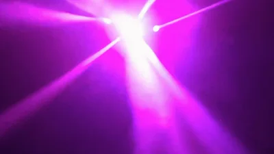 Dynamic Multi Colored Stage Lighting Beams In Dark Space