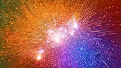 Vibrant Multicolored Fireworks Exploding Against Dark Background