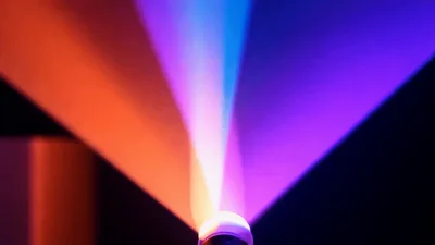 Colorful LED Light Projector Beams Rotating In Dark Room