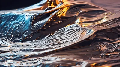Golden Liquid Pouring Onto Reflective Metallic Surface