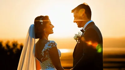 Newlywed Couple Holding Hands During Golden Hour Sunset