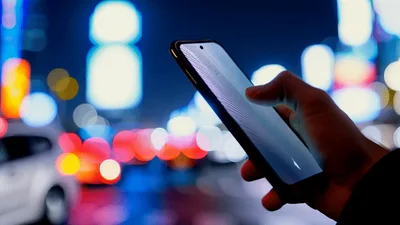 Person Using Smartphone With Glowing Interface At Night