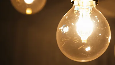 Vintage Edison Light Bulbs Glowing Brightly In Dark Room