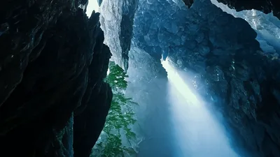 Sunlight Beams Shining Into A Deep Rocky Sea Cave