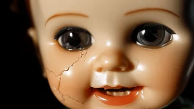 Creepy Vintage Doll Face With Cracked Skin Close Up