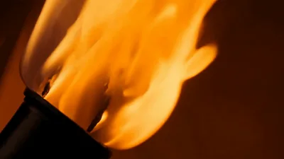 Bright Orange Torch Flame Burning In Dark Background