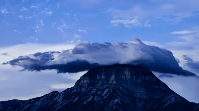 Lenticular Cloud Over Mountain Peak During Nightfall