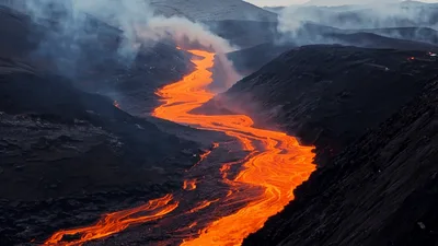 Molten Lava Flowing Through Volcanic Valley Landscape
