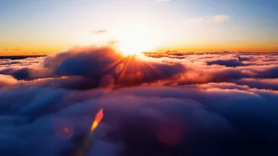Aerial View Of Sun Rising Above Thick Cloud Layer