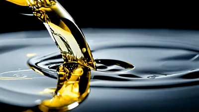 Golden Oil Pouring Into A Pool Of Liquid