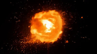 Burning Torch With Flying Sparks Against Black Background