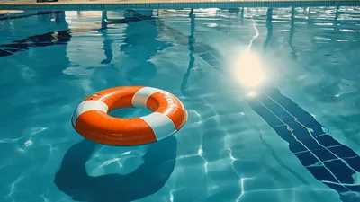 Orange Life Buoy Floating In A Swimming Pool