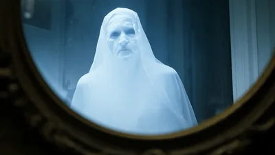 Ghostly Figure Appearing In An Antique Wall Mirror