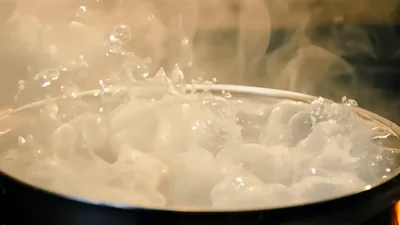 Boiling Water Bubbling Vigorously In A Metal Pot