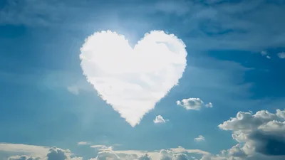Heart Shaped Cloud Forming In Blue Sky