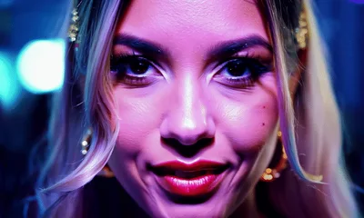 Young Woman Smiling At Camera In Nightclub Setting