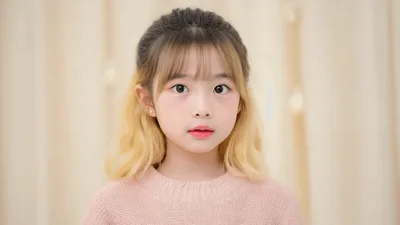 Young Girl With Blonde Highlights Looking At Camera
