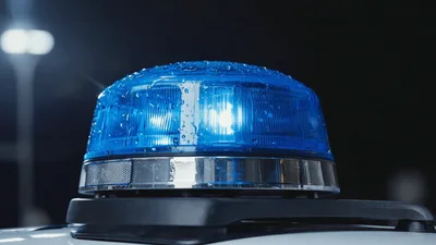Blue Emergency Light Flashing On Police Car Roof