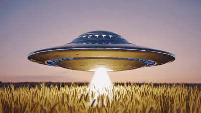 UFO Hovering Over Wheat Field Emitting Light Beam