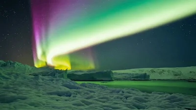Vibrant Aurora Borealis Dancing Over Arctic Ice Landscape