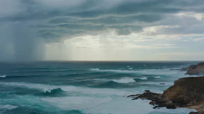 Stormy Ocean Waves Crashing Against Rugged Coastal Cliffs