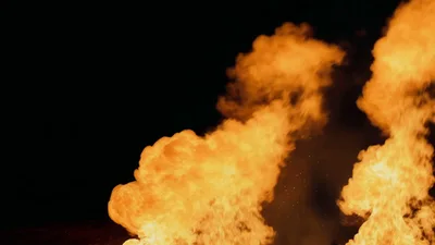 Large Intense Fire Flames Burning Against Black Background