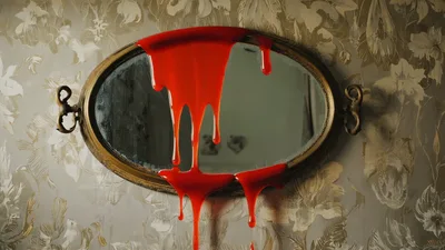 Red Liquid Dripping Down An Antique Oval Mirror