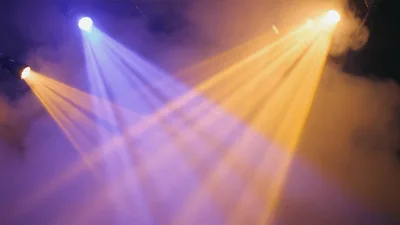 Stage Spotlights Shining Through Haze In Dark Venue