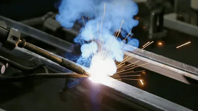 Automated Robotic Arm Welding Metal Parts In Factory