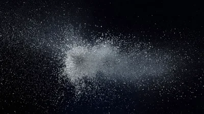 White Powder Explosion Against A Black Background