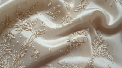 Close Up Of Elegant Cream Silk Fabric With Embroidery
