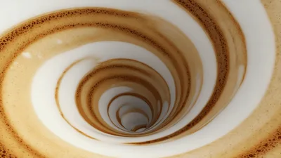 Coffee Foam Swirling In A White Ceramic Cup