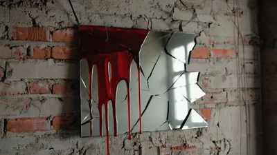 Red Paint Dripping Down A Broken Mirror On Brick Wall